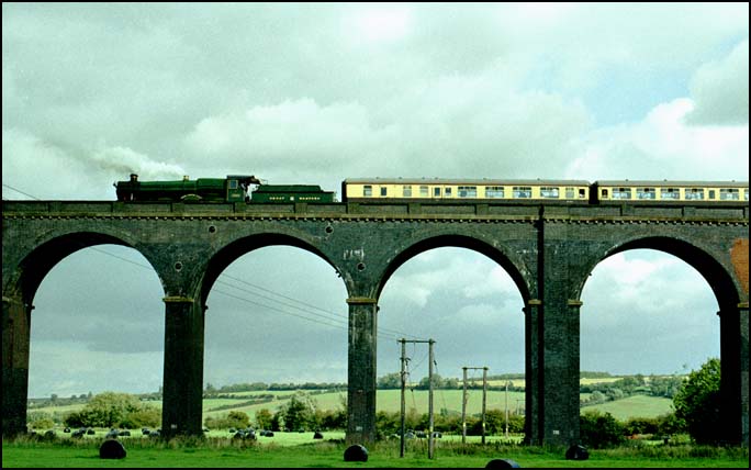 Just four of the 82 arches of the Harringworth Viaduct, with a GWR Hall going over it.