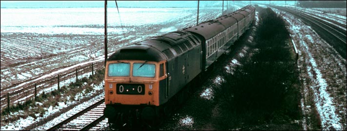 Class 47 on the Stamford to Peterborough line between Helpston and Woodcroft crossings gates