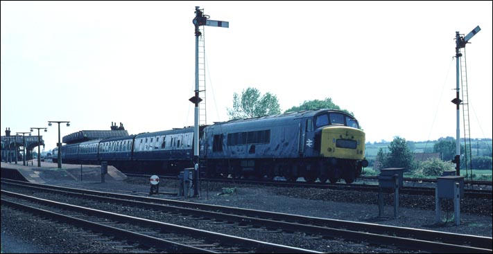 Class 45122 leaves Kettering station on a down train.