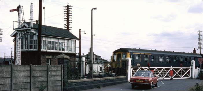 A DMU over the level crossing at Sincil Bank in BR days