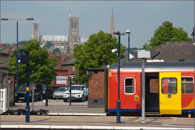 Lincoln station on 24th May in 2012 with a East Midlands Trains unit in the bay with the cathedral in the background