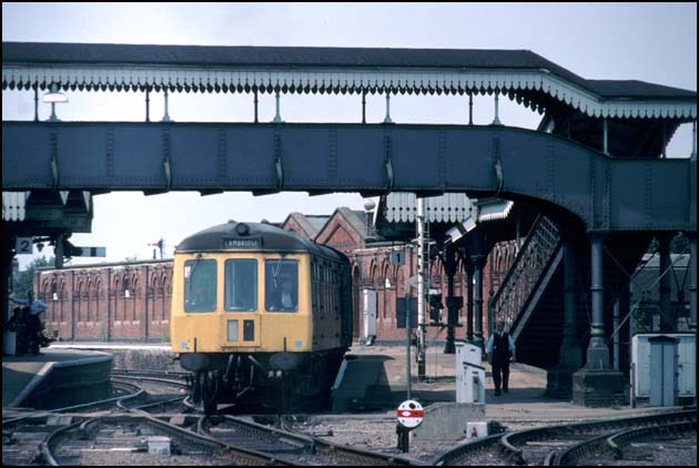 A DMU gets the signal t out of the now disused GN&GEJR platform 1 at March 