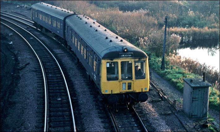 A DMU to Doncaster comes round the eastern side of the triangular junction at Whitemoor 