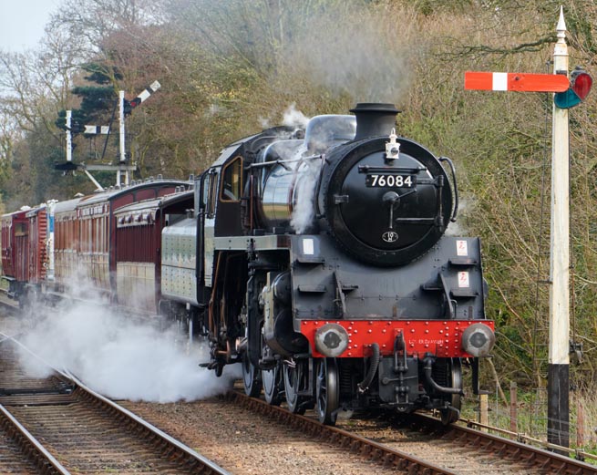 76084  into Holt station with a mixed vintage train