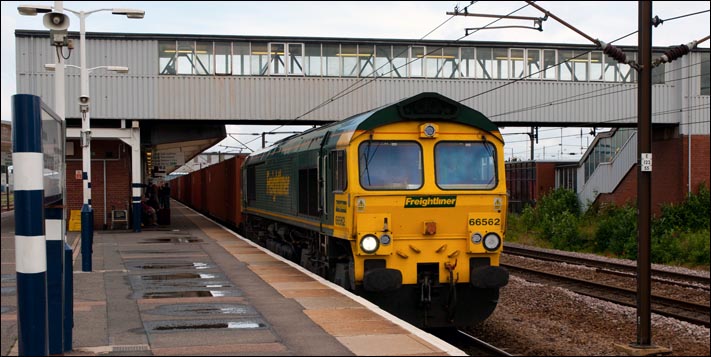 On a dull damp morning Freightliner class 66562 is in platform 4 on the 6th of June 2012
