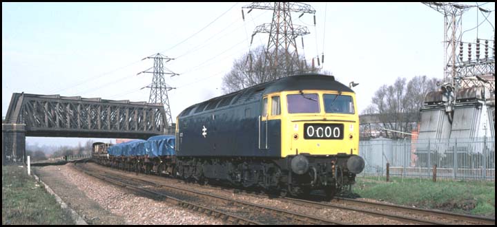 A Class 47 on the line to March and Ely next to Fair ground car park at Peterborough
