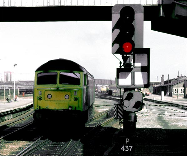 A class 47 comes into platform 2 under the Post office foot Bridge and past signal P437