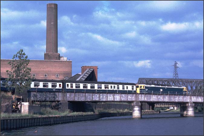 Class 47 over the River Nene in the late 1970s when Peterborough Power station was still in place
