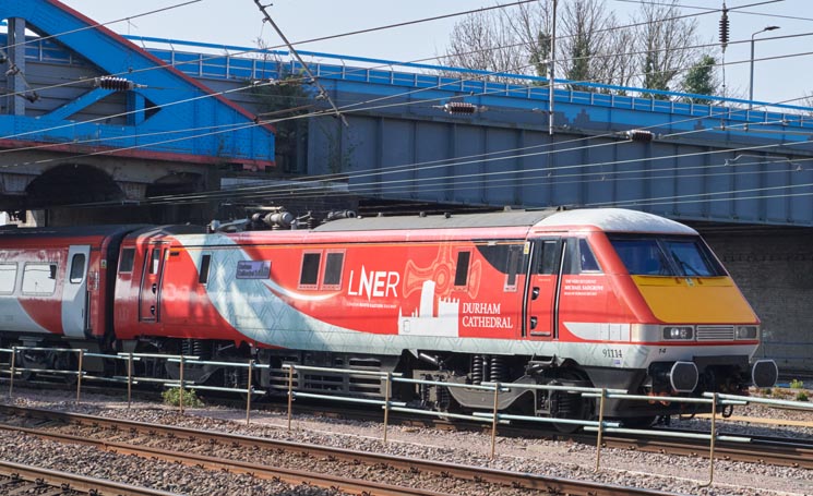 LNER class 91114 Durham Cathedral at Peterborough station coming under Cresent Bridge on the 16th of April  in 2022 