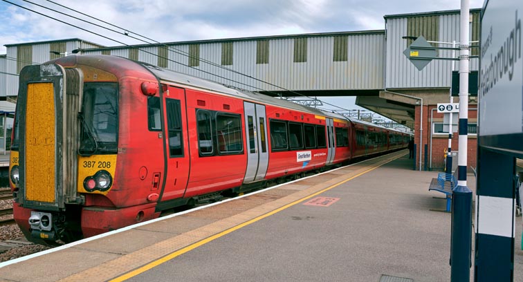 Great Northern class 387 208 in red at Peterborough station in platform 4 on  16th of June 2022