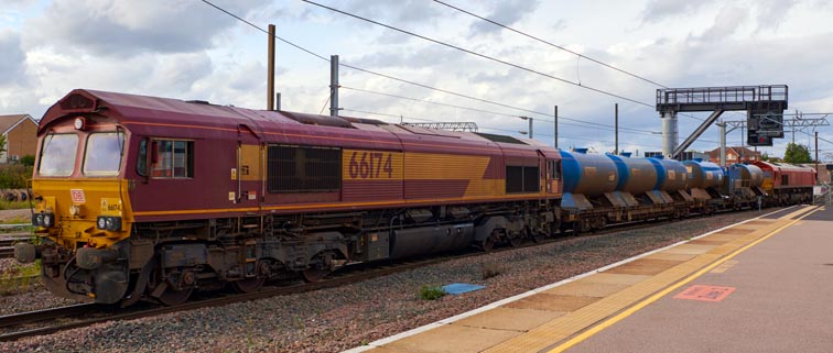 DB class 66174 coming into platform 6 at Peterborough station with a Leaf Fall train 