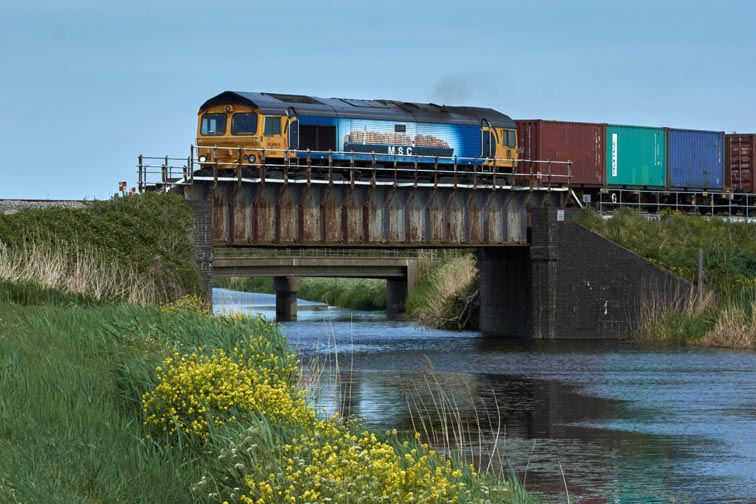 GBRf class 66709 in MSC colours on the 20 Foot River (drain) bridge at Tuves 18th May 2022 .