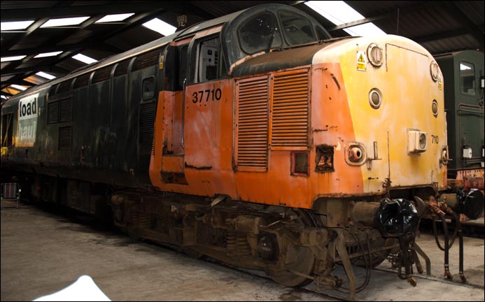 Class 37710 in Load haul colours in the shed at Carnforth