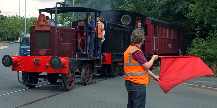Hunslet diesel locomotve Courage crossing the road with 7051 