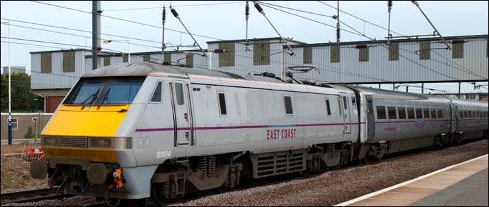 East Coast class 91104 on the down fast at Peterborough station on the 17th of June 2013