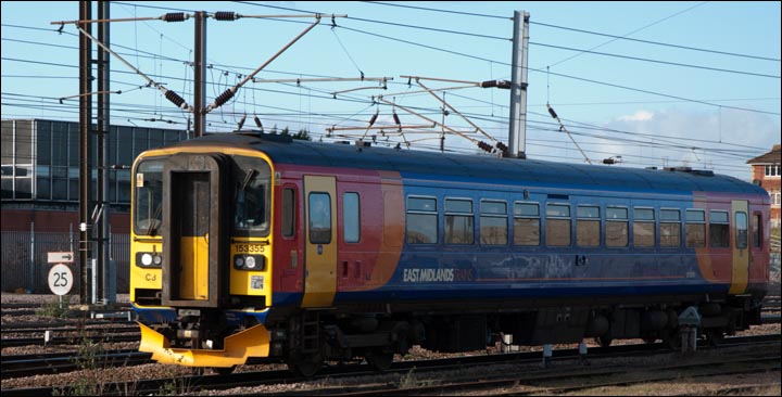 East Midlands Trains class 153355 with Peterborough Power signal box behind on the 13th of February 2014