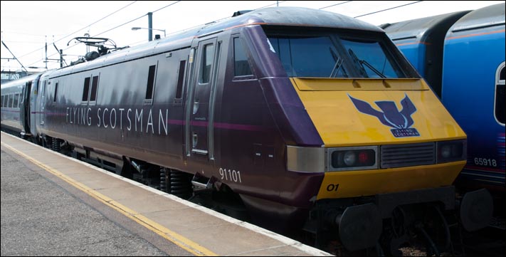 East Coast class 91101 with its Flying Scotsman logos on an up train in platform 2 at Peterborough on the 4th of June 2011