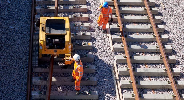 One of the rails is being pulled over  from the ballast on the left towards the right