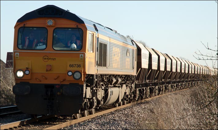 GBRf class 66736 at Black bush level crossing  on a train of hooper wagons on Monday 13th of January